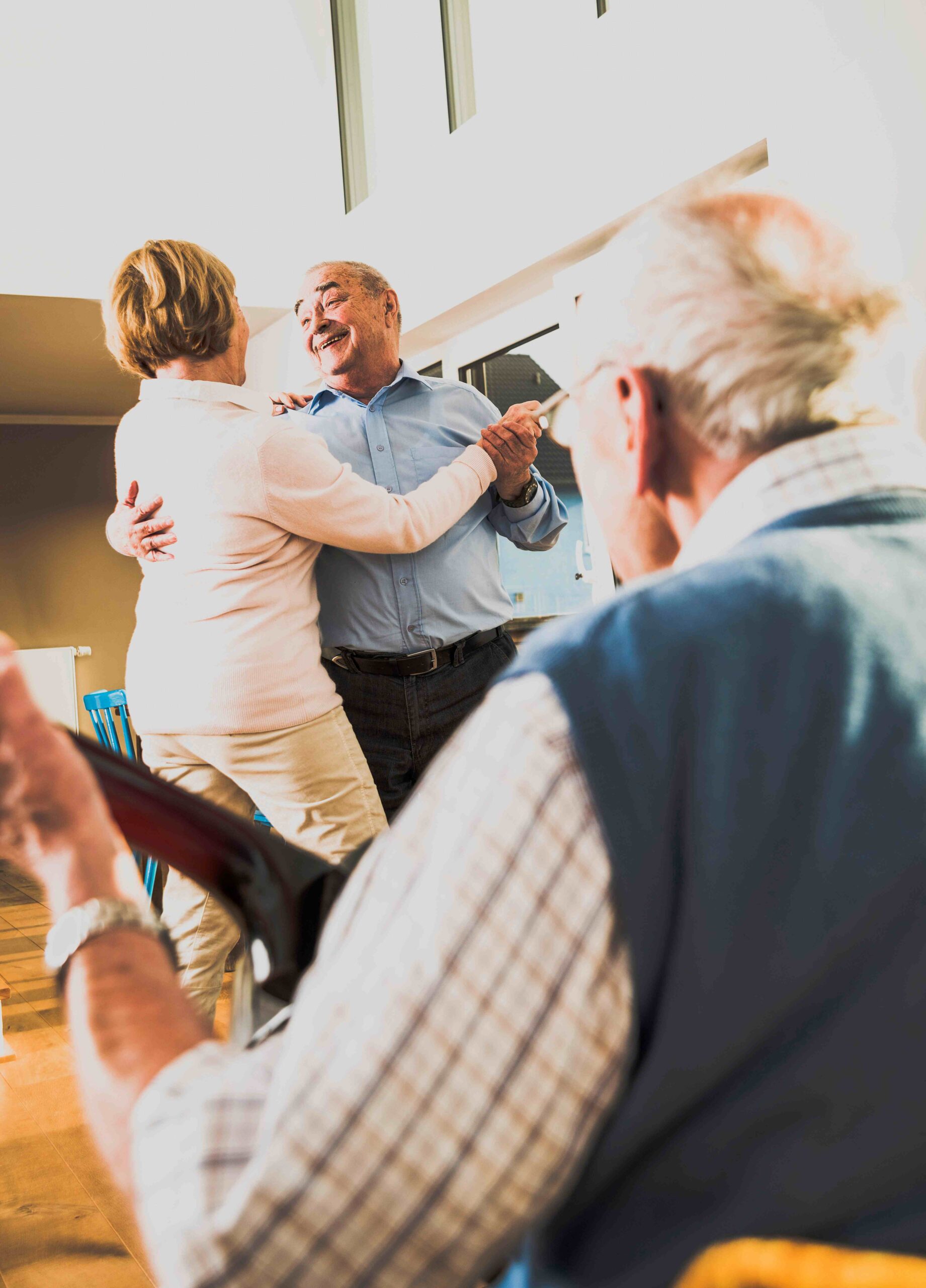 Senior man playing guitar for senior couple dancing